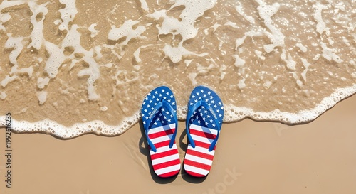 A top down view of blue flip flops resting on a sandy beach with gentle waves washing ashore evoking summer vibes