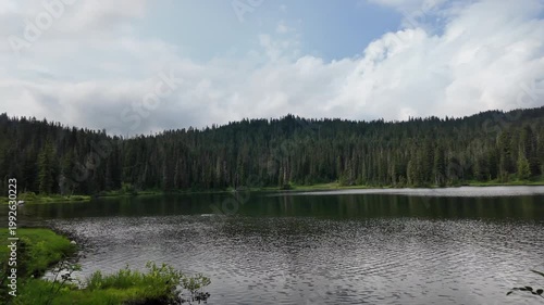Rainier lake in National Park. Scenic nature view over Rainier lake. Lake with mountain landscape. Landscape of mountain peak and Rainier lake. Nature landscape