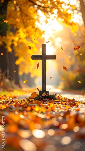 Wooden cross surrounded by autumn foliage on a sunlit pathway through golden trees