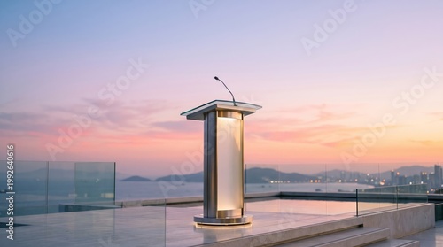 Modern rooftop podium with microphone at sunset overlooking city skyline and ocean