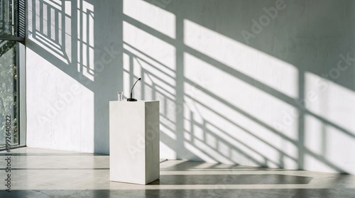 Modern white podium with microphone and glass of water indoors