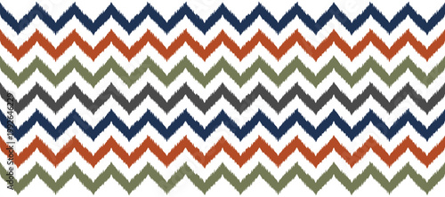 Seamless ikat zig-zag pattern with blurry dyed lines in navy blue, rust, olive green, and dark gray.