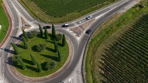 High angle birds eye view of a roundabout and road markings in the Veneto region, highlighting the integration of civil engineering and sustainable design in a rural environment.