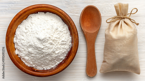 bowl of white powder with a wooden spoon and bag