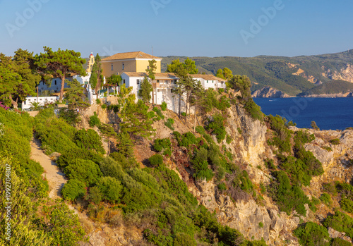 Paleokastritsa Monastery on rocky cliff in Corfu, Greece
