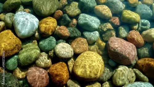 Colorful pebbles submerged in clear water