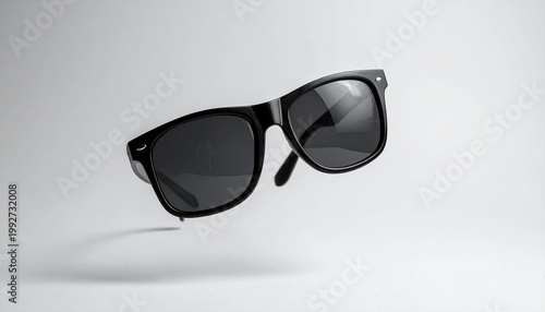Stylish sunglasses floating gracefully, embodying a sense of modern chic and summer relaxation. The sunglasses exude a timeless appeal and sophistication