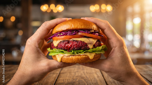 Plant-Based Vegan Burger with Beet “Bleeding” Patty Held in Hands, Gourmet Healthy Food Concept