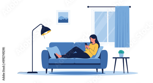 Young woman sitting on a blue sofa and using her smartphone for social media, messaging, or mobile gaming in a bright, modern living room.