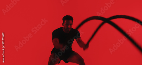 Foto Man, fitness and battle rope in studio with exercise, strength training and intense physical activity