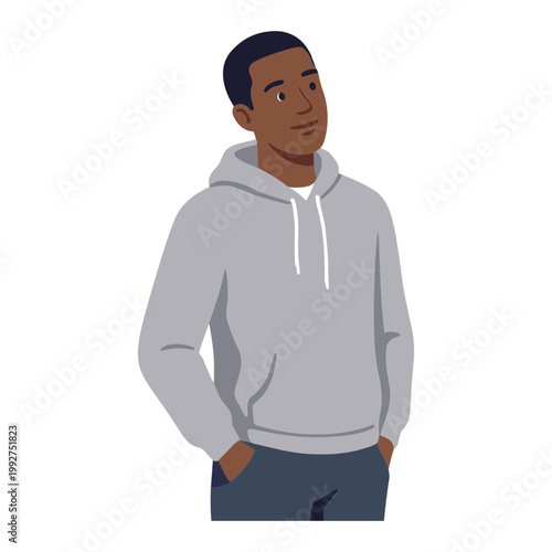 Man wearing gray hoodie standing with hands in pockets looking sideways