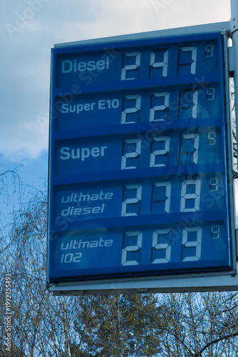 Gas station price board showing record high fuel costs during economic crisis
