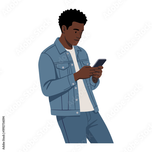 A man in a denim outfit is focused on his phone.