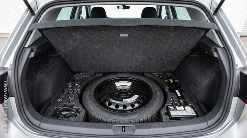 Spare Tire Stored Neatly in a Car Trunk Compartment, Organized Tools, Clean Interior, Soft Lighting, Automotive Organization Concept
