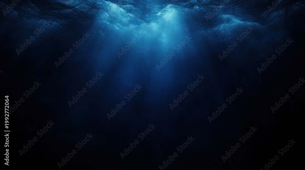 Obraz premium deep blue ocean with shafts of sunlight piercing dark water, evoking a serene, mysterious and immersive underwater atmosphere