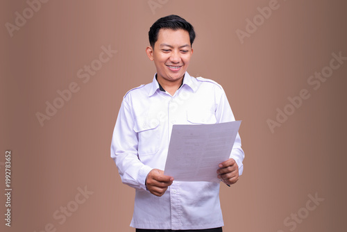 Asian Office Worker Happily Reviewing Paperwork or Contract