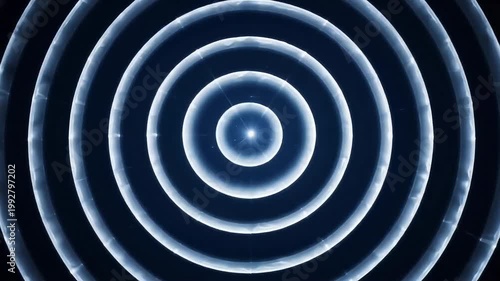 A futuristic abstract background featuring glowing blue concentric circles and neon light rings creates a sleek digital design element