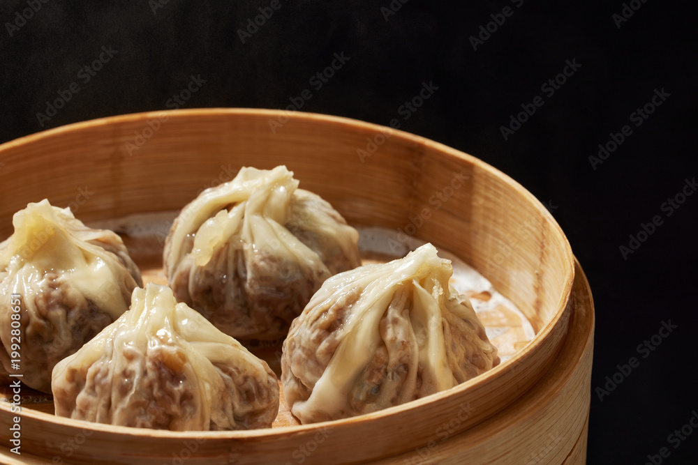 Fototapeta premium Steamed shaomai dumplings in bamboo basket