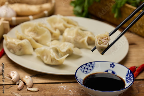 Cuadro en lienzo Boiled dumplings with soy vinegar dipping sauce and chopsticks on rustic table