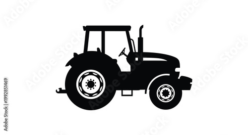 A striking black silhouette of a classic farm tractor against a white backdrop silhouette