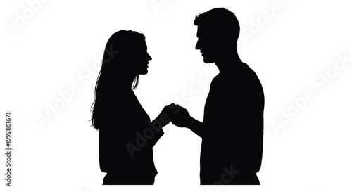 Couple holding hands facing each other in a striking black silhouette