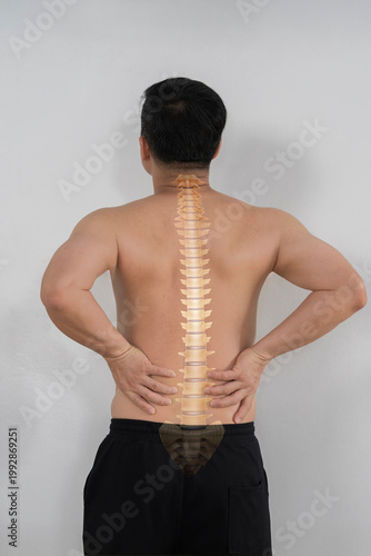 Konstfotografi Back view of Asian man with lower back pain and spine anatomy overlay