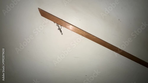 Wooden stair handrail mounted on wall with metal bracket showing interior home detail and safety feature