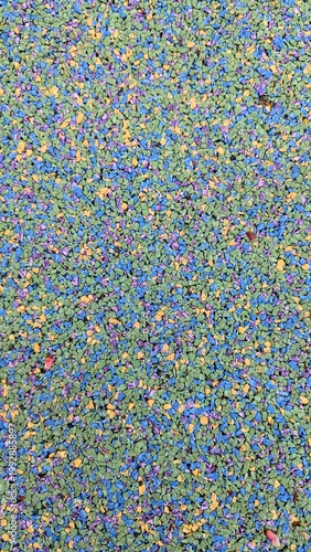 Colorful rubber granule playground surface texture, safety flooring background