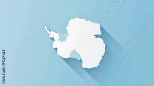 Minimalist white silhouette map of Antarctica with a long shadow on a light blue background, representing the frozen continent.