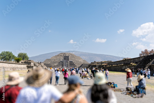Visitors explore Avenue of the Dead with Pyramid of the Sun in Teotihuacan archaeological site