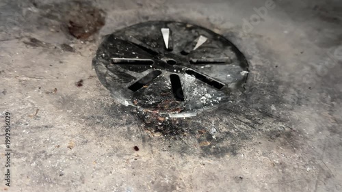 Indoor basement floor drain detail in concrete slab showing household drainage and plumbing maintenance concept