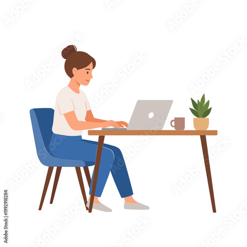 A woman sits at a desk typing on her laptop beside a plant and coffee mug.