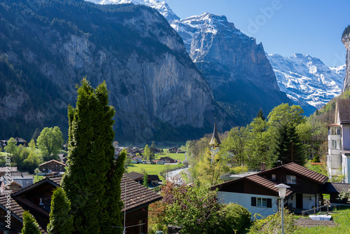 Amazing view of the picturesque alpine town of Lauterbrunnen, Switzerland. The village church and the Staubbach Falls in Lauterbrunnen