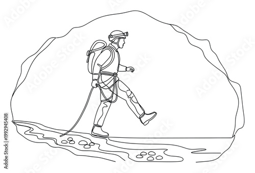 Explorer equipped with caving gear walking through an underground cave tunnel, suitable for adventure and tourism marketing materials