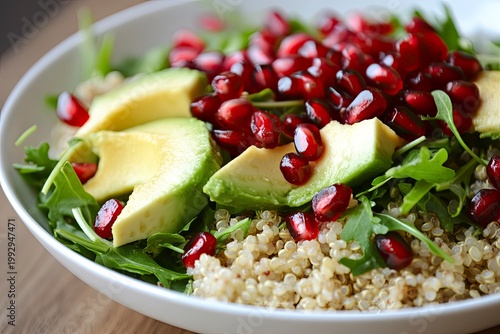 Healthy vegan salad with quinoa, greens, and pomegranate, healthy eating concept