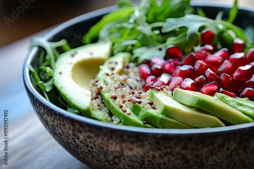 A vibrant dish with quinoa, avocado, arugula, and pomegranate, a healthy eating concept