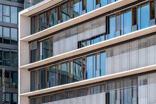 Modern apartment facade architecture with residential windows glass and louver creating geometric pattern for real estate marketing showing exterior detail