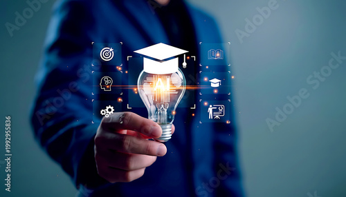Businessman holding glowing education icon for digital learning.