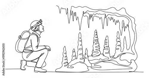 Speleologist with headlamp and backpack observing intricate stalactite and stalagmite formations in a cave for adventure and discovery content