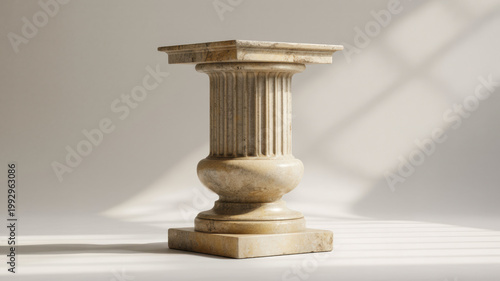 A classic stone column pedestal stands elegantly in a minimalist setting with sunlit shadows