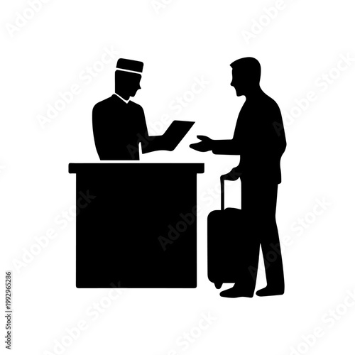 Hotel staff assisting arriving traveler at the reception desk