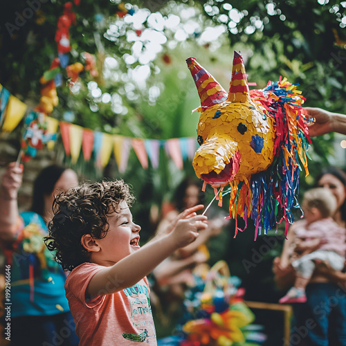 Child celebrating with colorful pinata at birthday party family gathering outdoor setting joyful atmosphere