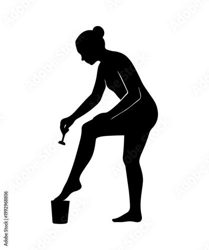 Woman shaving leg with razor for body care and beauty routine