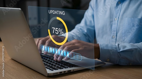 Man in a blue shirt working on a laptop with a software update progress bar displayed