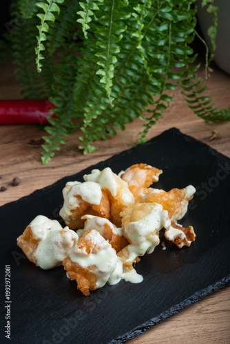 Fried potatoes with cheese and white sauce