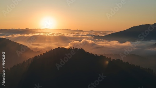Dreamy mountain landscape above the clouds at sunset, cinematic golden light and silhouettes.
