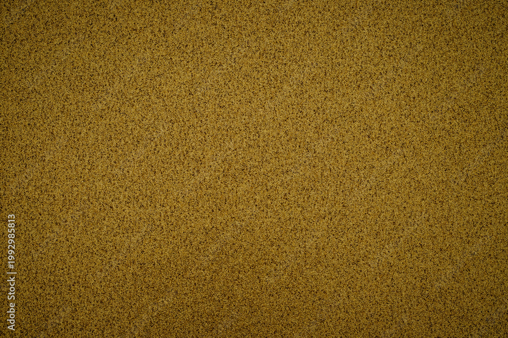 Fototapeta premium Close up view of sandy texture on the beach showing warm tones of golden sand under sunlight in mid-afternoon hours