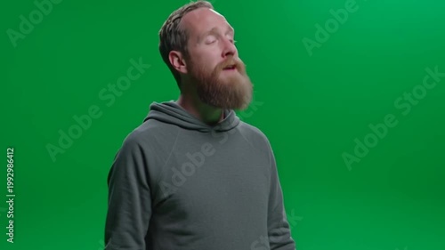 Bearded Man with Closed Eyes Looking Up on Green Screen.