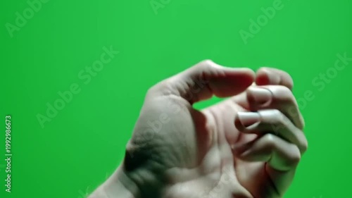 Hand pointing then clenching into a fist on green screen background.