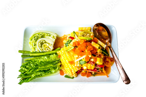 A plate of spicy Thai corn salad(Som Tum Khao Pod) on a white plate and white background. The dish is topped with salted egg.